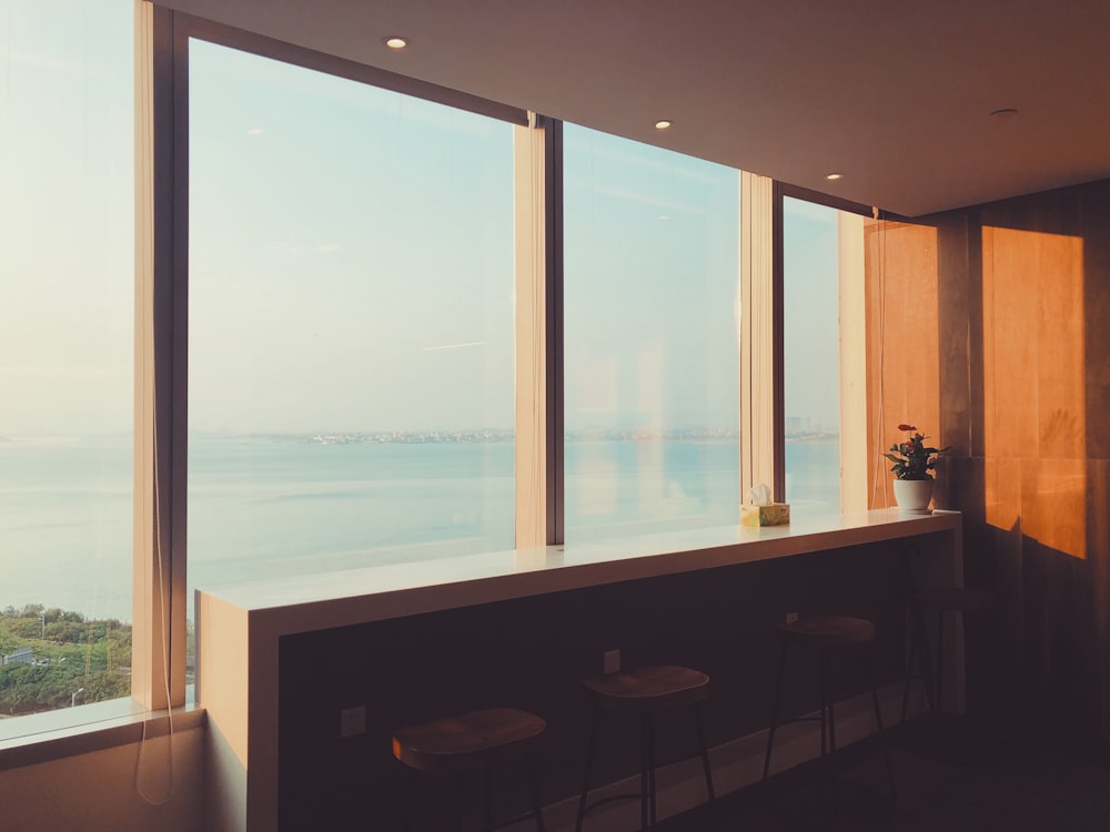 white wooden table beside window