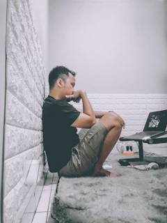 A thoughtful person reading AI news on a laptop in a cozy room.