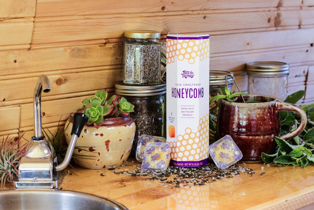 honey container beside clear glass jars