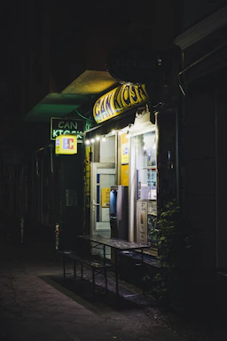 A friendly Oakstream technician installing an ATM inside a cozy local shop.