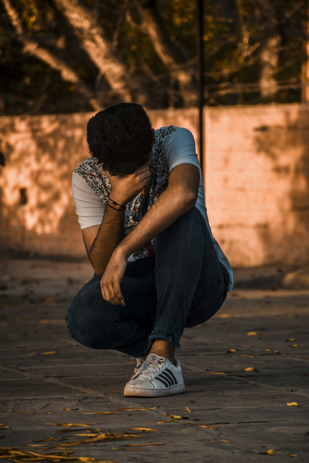 man kneeling on ground