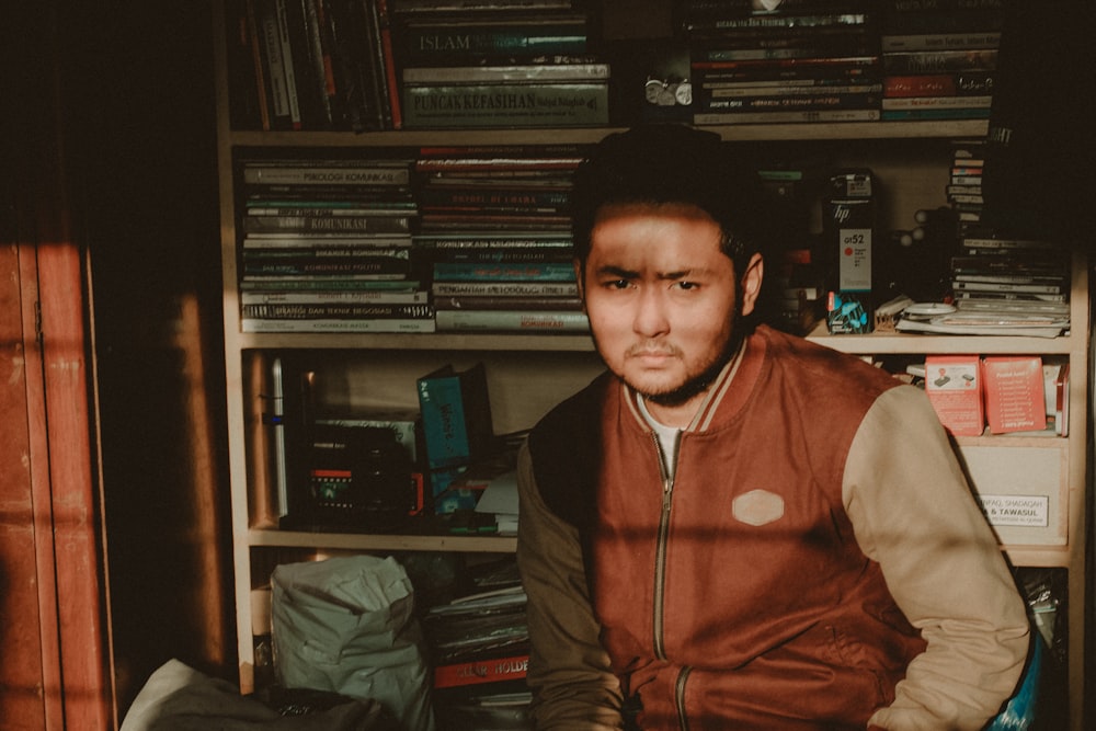 man in brown full-zip letterman jacket