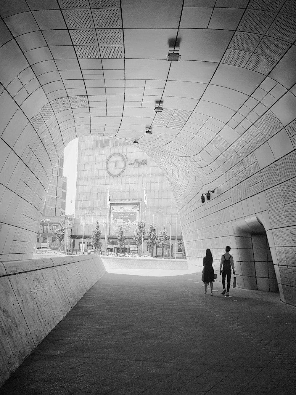 white concrete tunnel during daytime