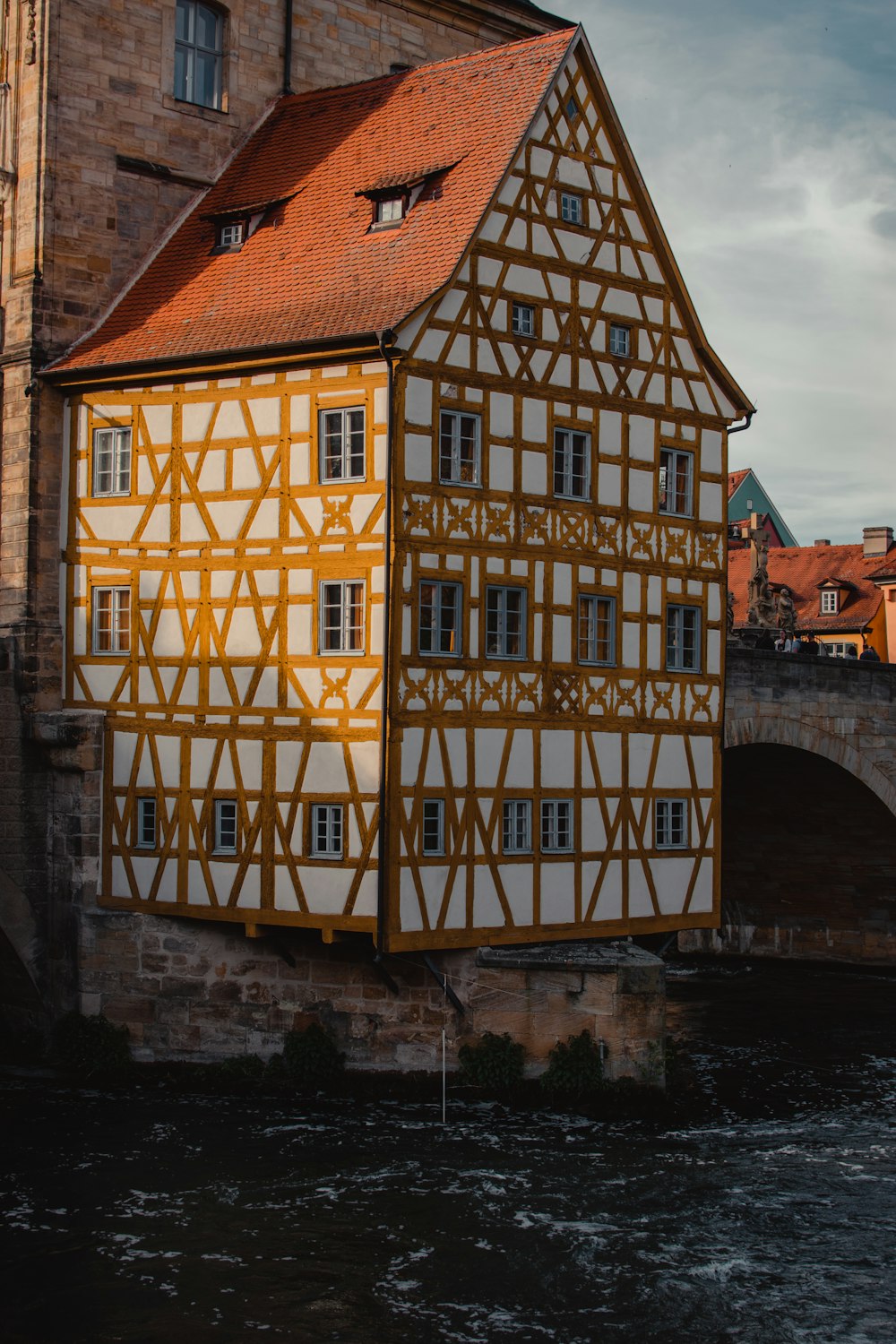 white and brown building near body of water during daytime