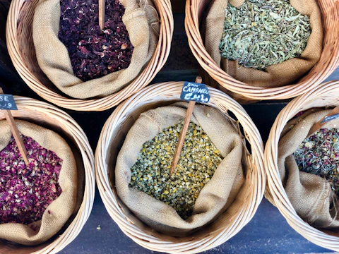 A rustic wooden drying rack filled with freshly harvested herbs.