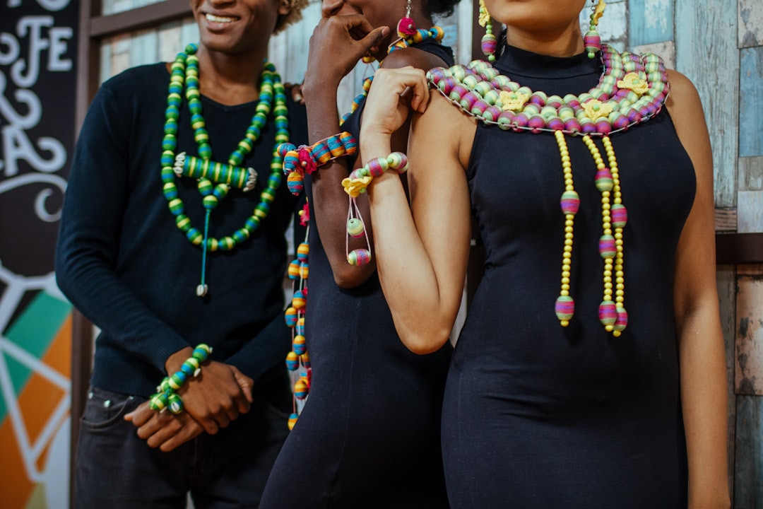 woman wearing black dress and multicolored necklace