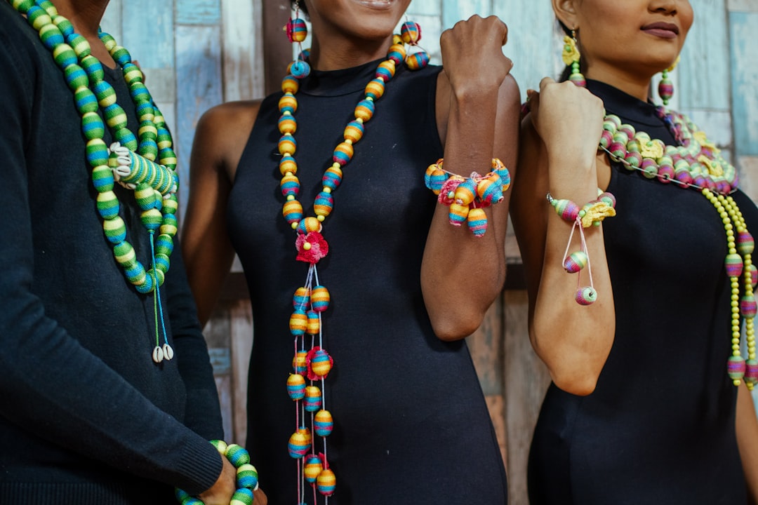 people wearing assorted-colored bead necklaces