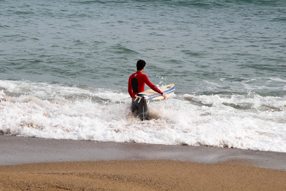 man holding surfboard