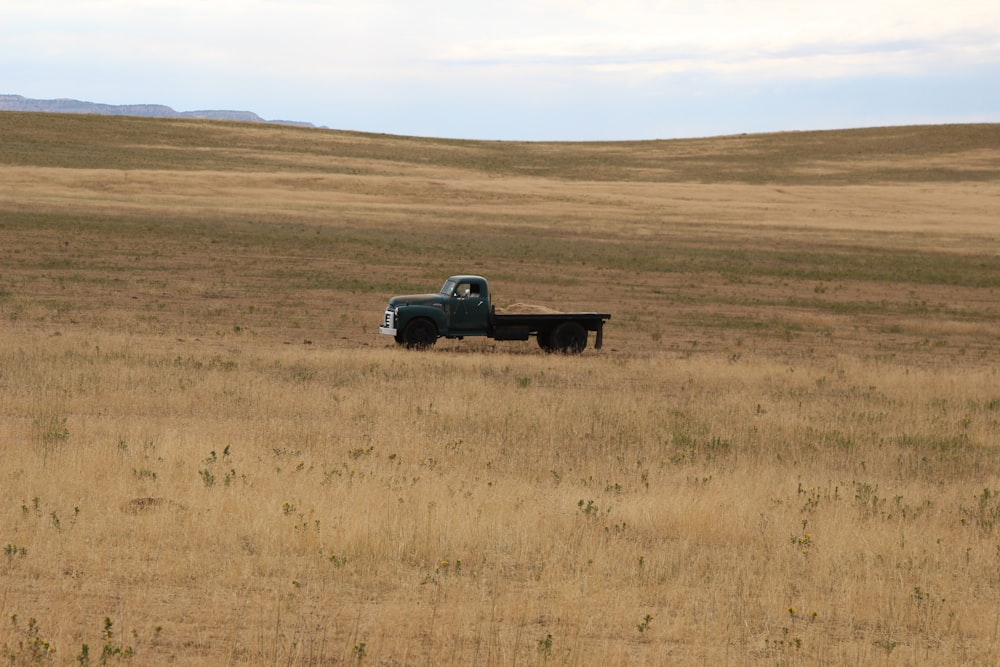 gray single-cab pickup truck at field during daytime