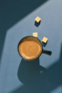 blue ceramic mug filled with coffee