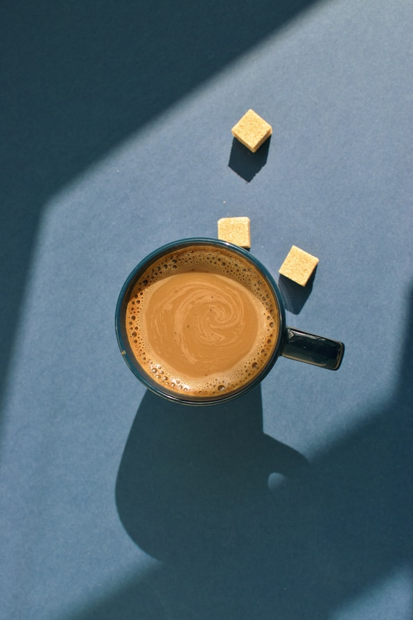 blue ceramic mug filled with coffee
