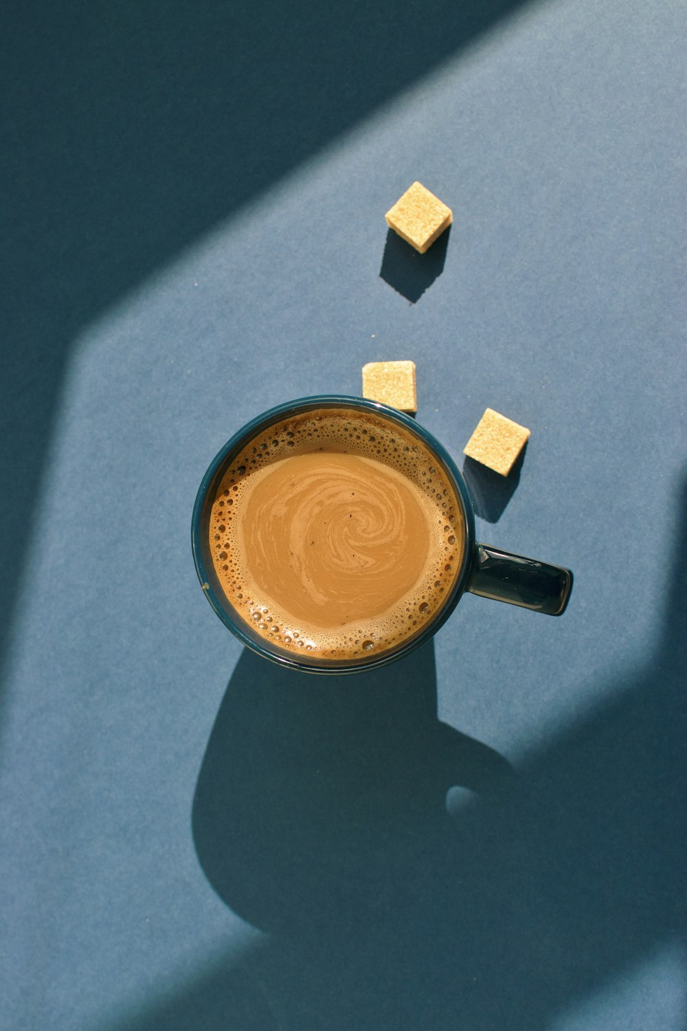 blue ceramic mug filled with coffee