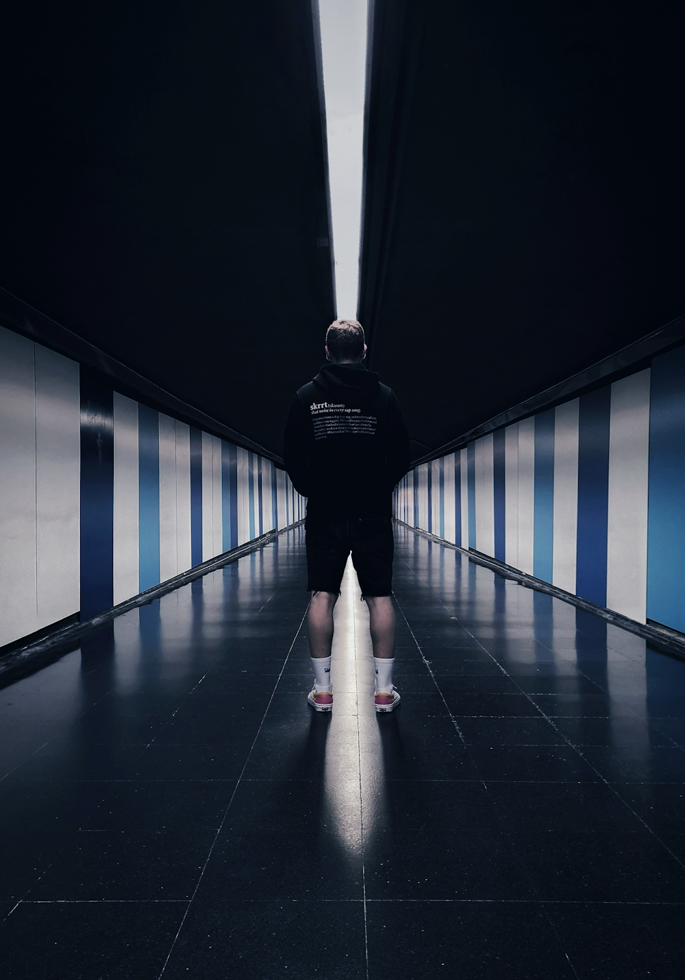 man standing on black floor tiles