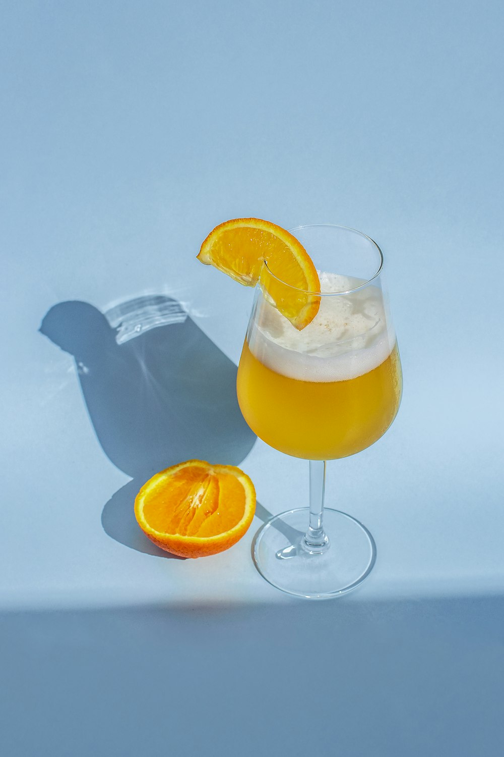 clear wine glass beside sliced lime fruit