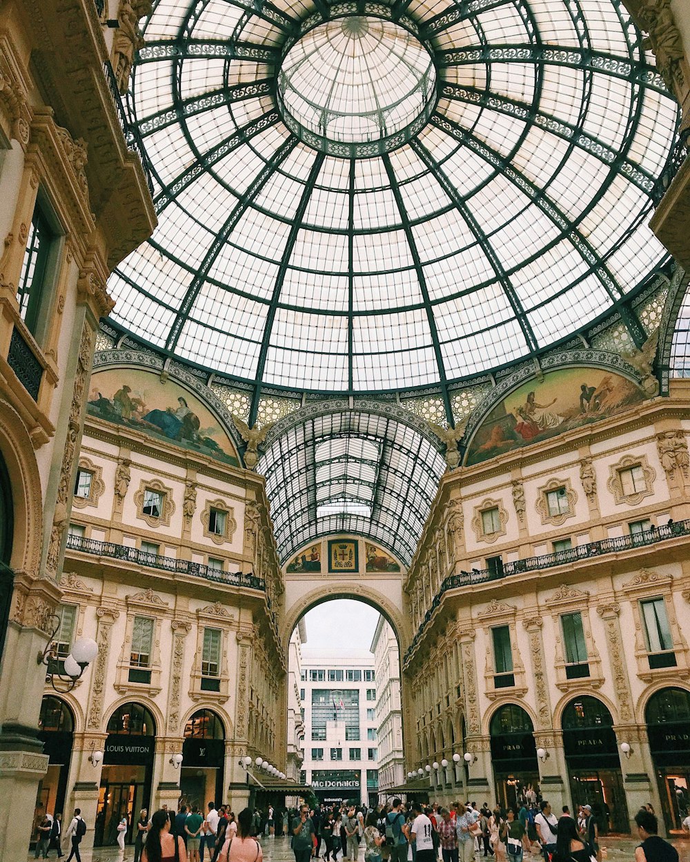 people walking in brown domed building