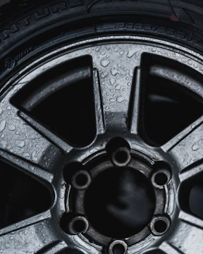Close-up of sparkling wet tires on a freshly washed car.