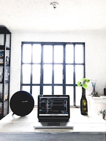 black-and-gray laptop computer on table