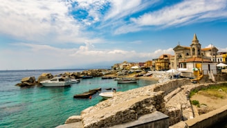 white motorboat at beach during daytime Messina, Italy