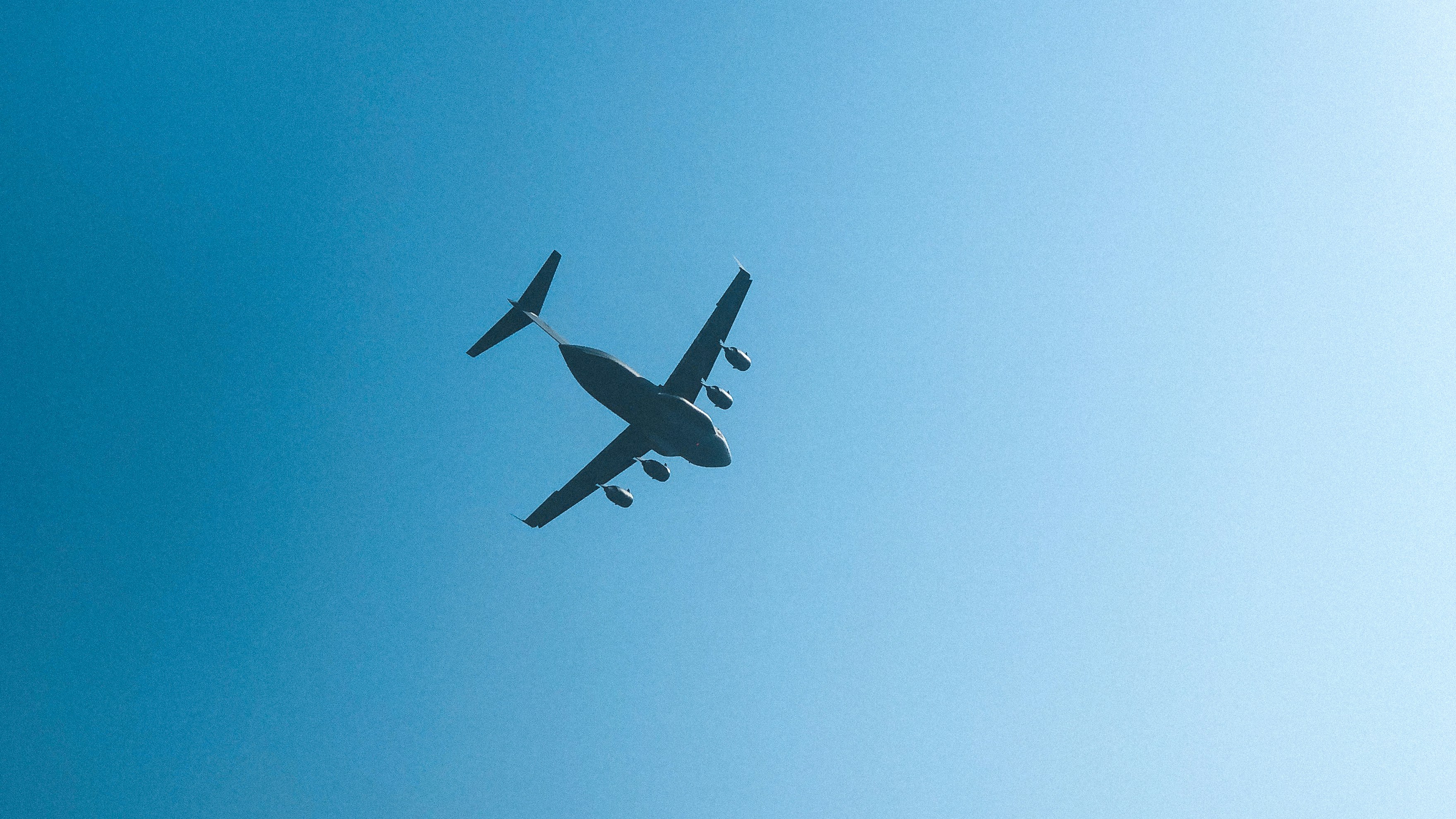 low angle photography of flying plane on high altitude