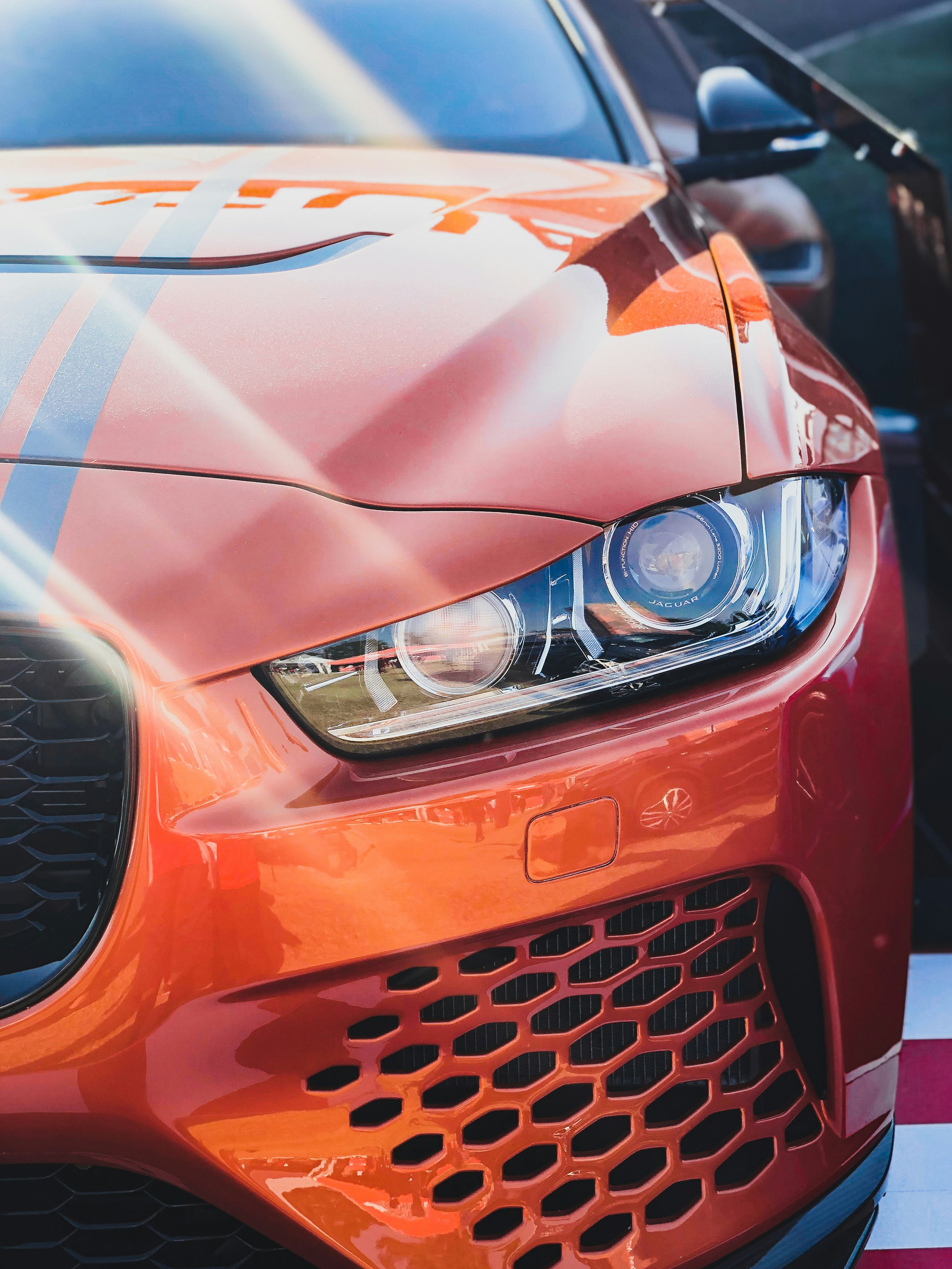 closeup photo of red vehicle during daytime