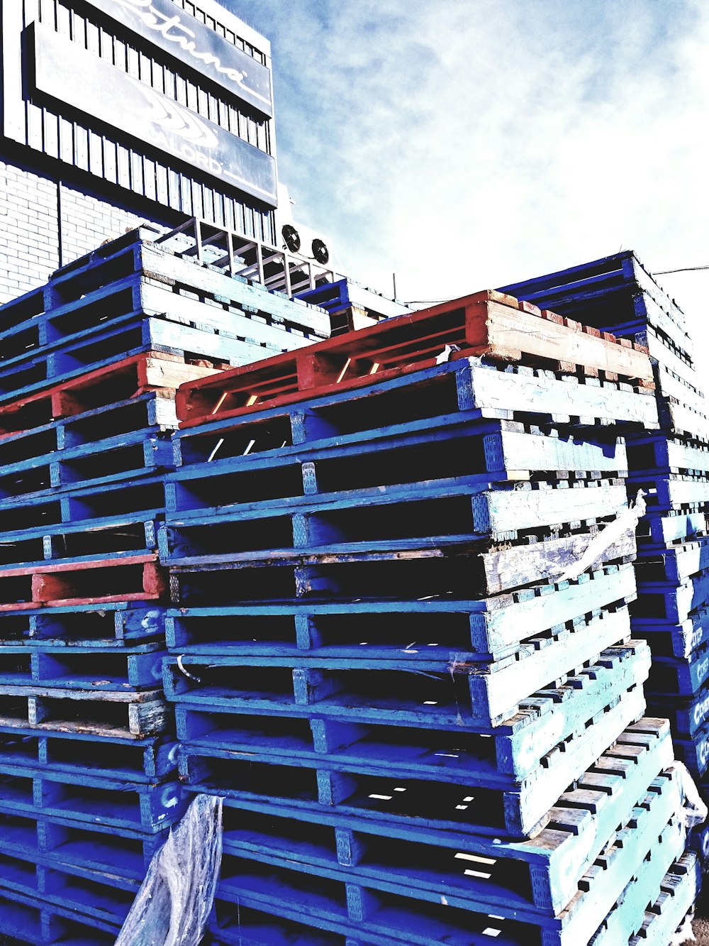 blue and red wooden pallets during daytime
