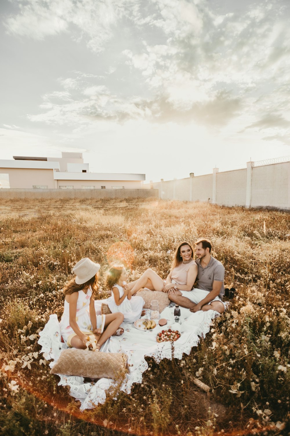 people sitting on picnic mat