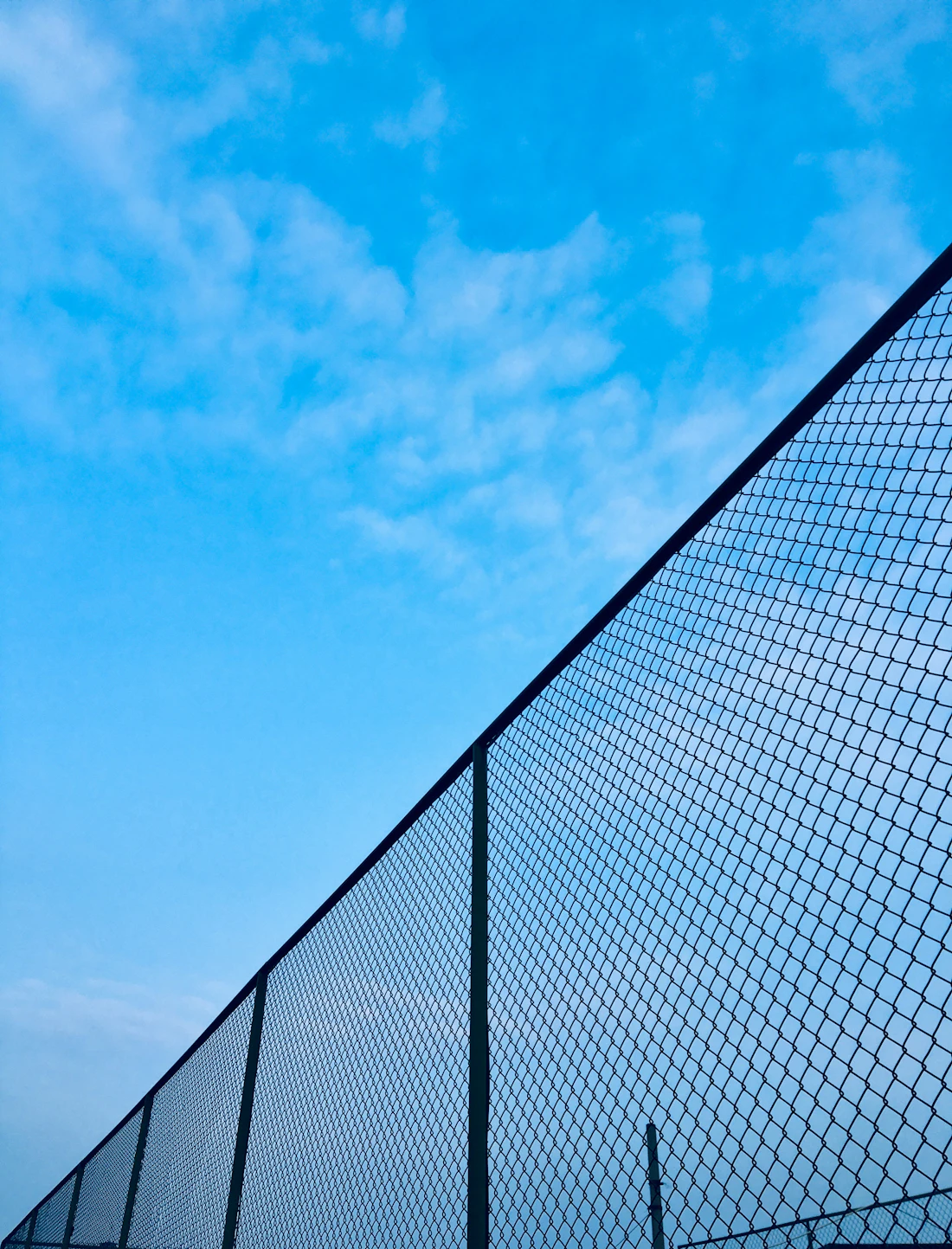 Chain link fence under a blue sky
