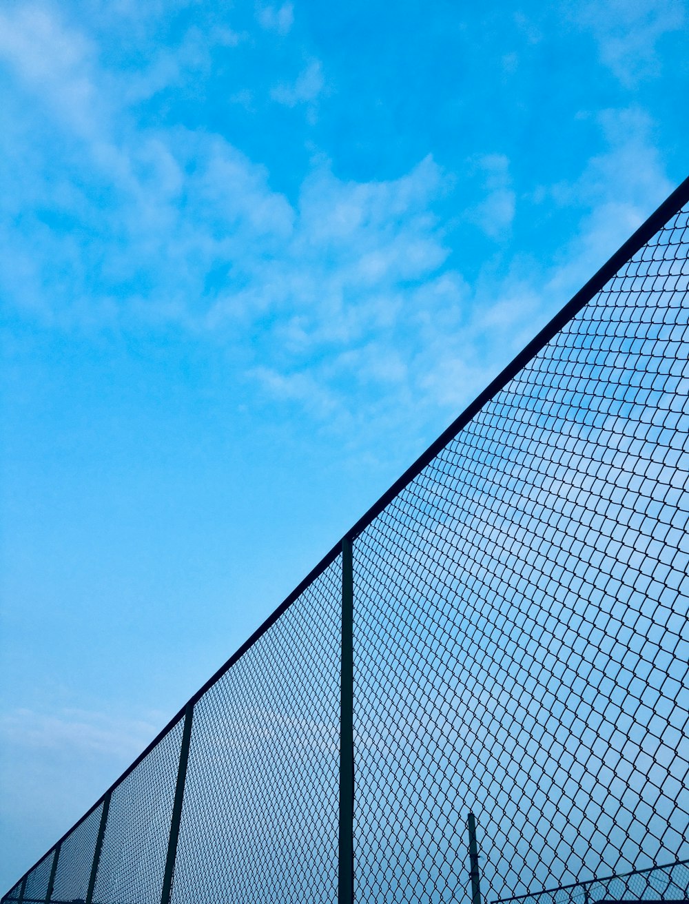 chain-link fence under blue sky during daytime