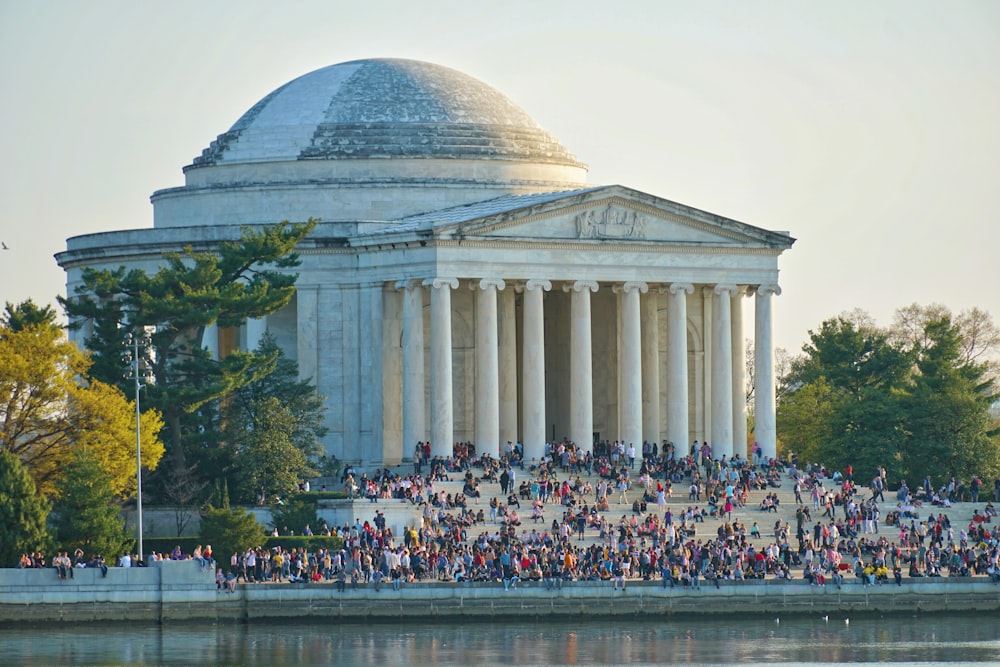 people gathering near white concrete building