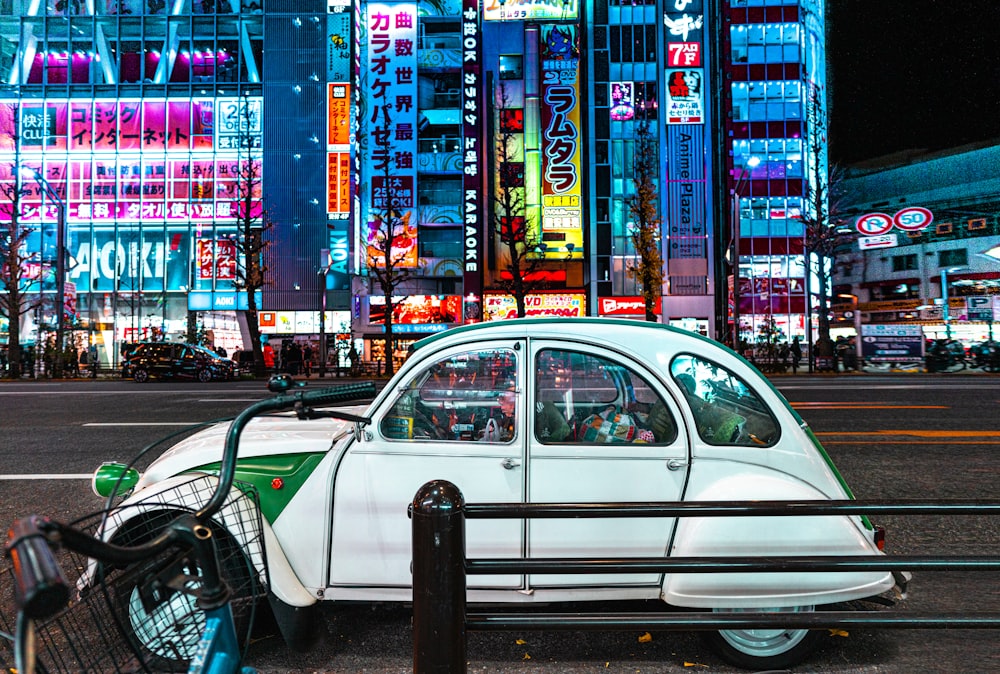 classic white Citroen 2CV on road at night