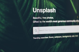 flat screen monitor turned-on displaying Unsplash