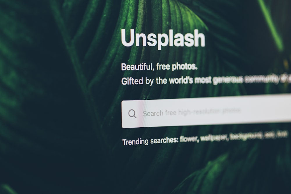 flat screen monitor turned-on displaying Unsplash