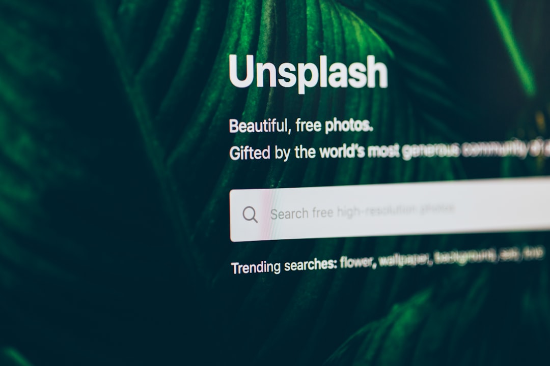 flat screen monitor turned-on displaying Unsplash