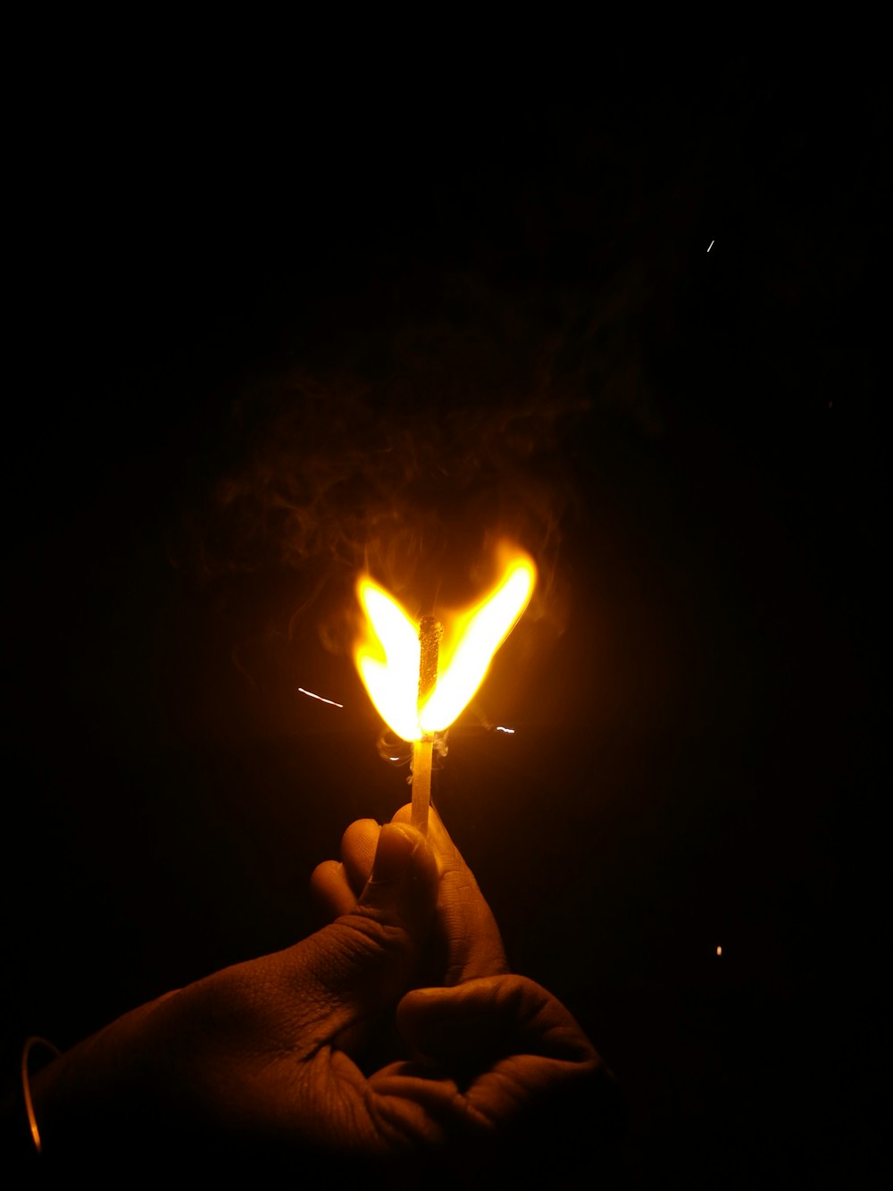 person holding lighted match stick