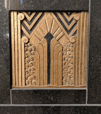 Modern architectural detail symbolizing strength and protection with dark tones and gold accents.