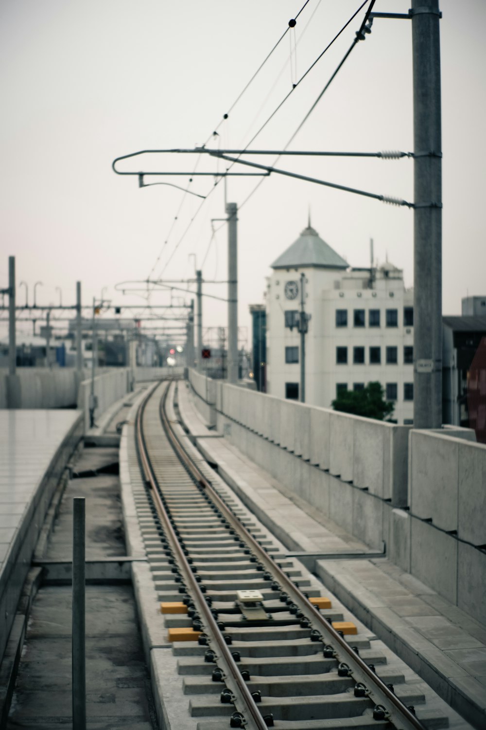 train tracks near buildings during day