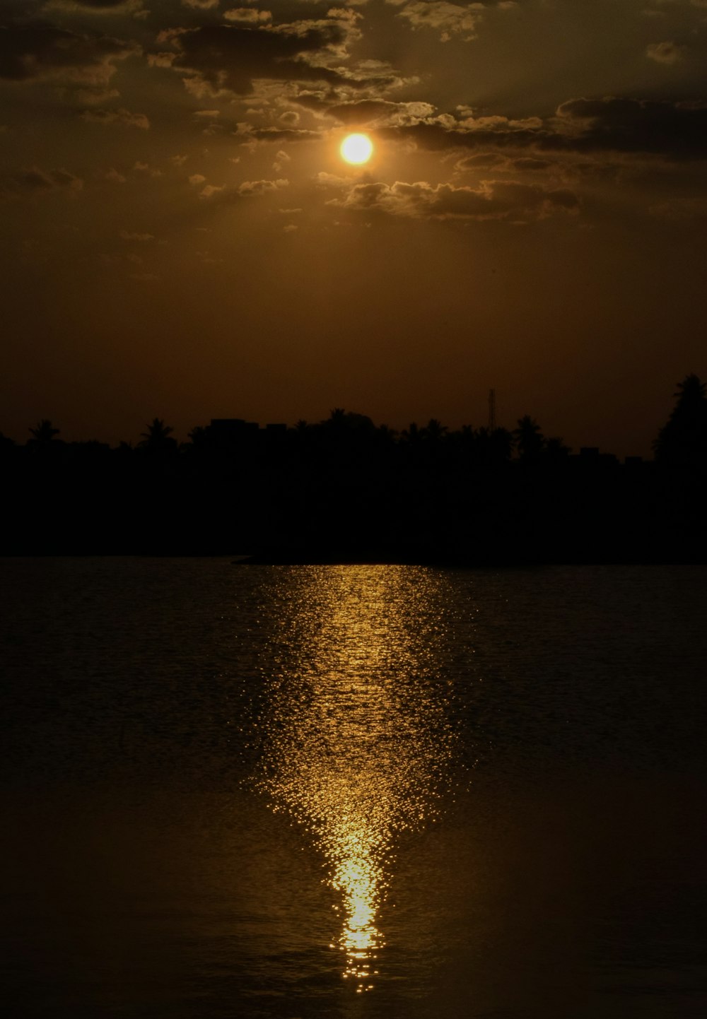 the sun is setting over a body of water