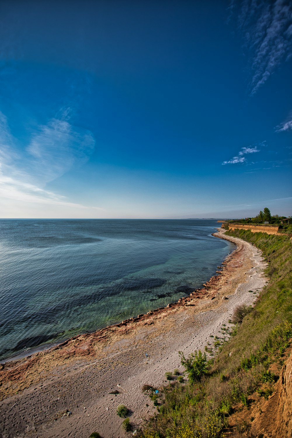 sand and grass covered island during day