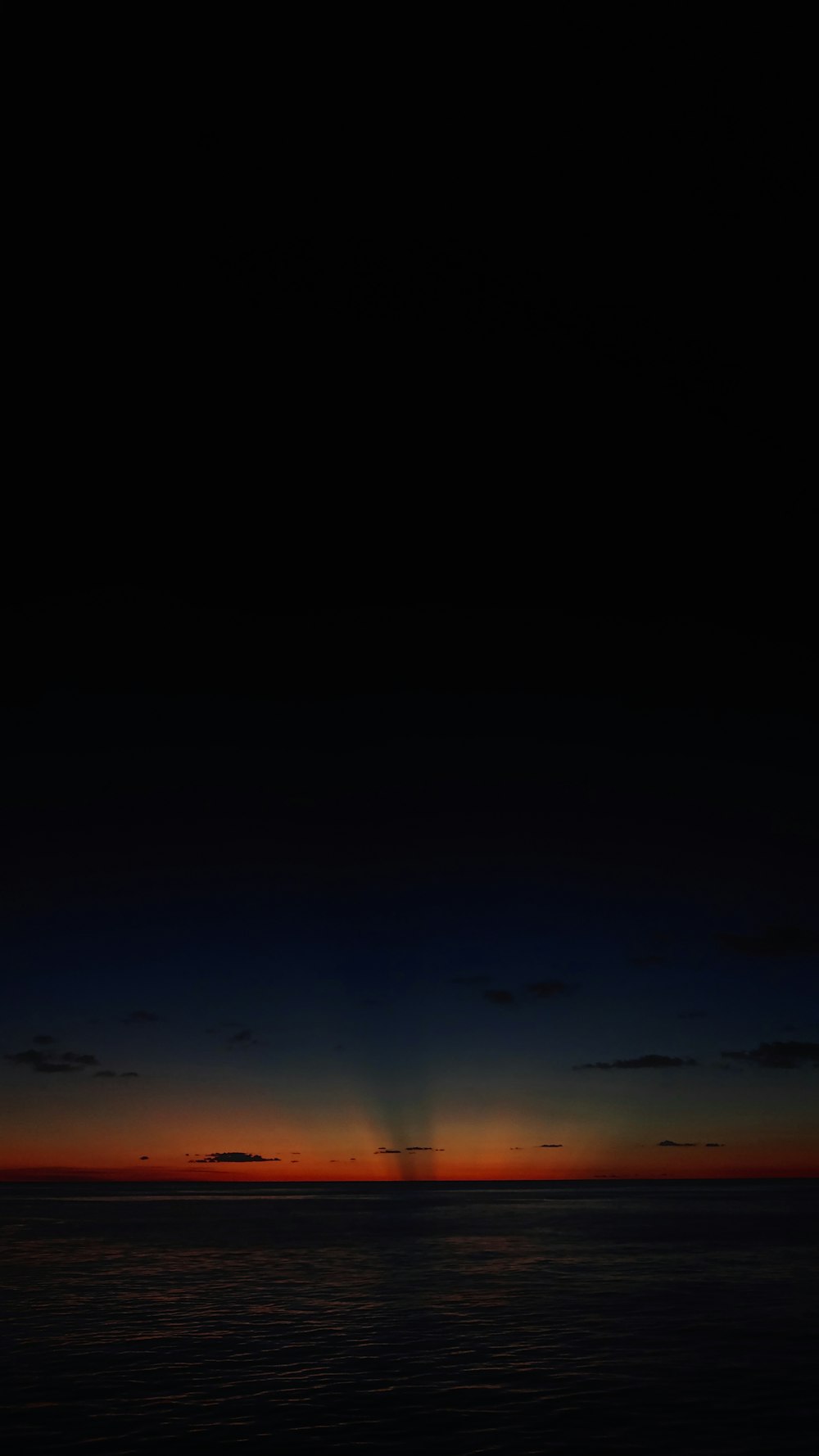 a plane flying over a body of water at night