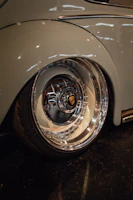 Shiny alloy wheels reflecting showroom lights on a polished floor