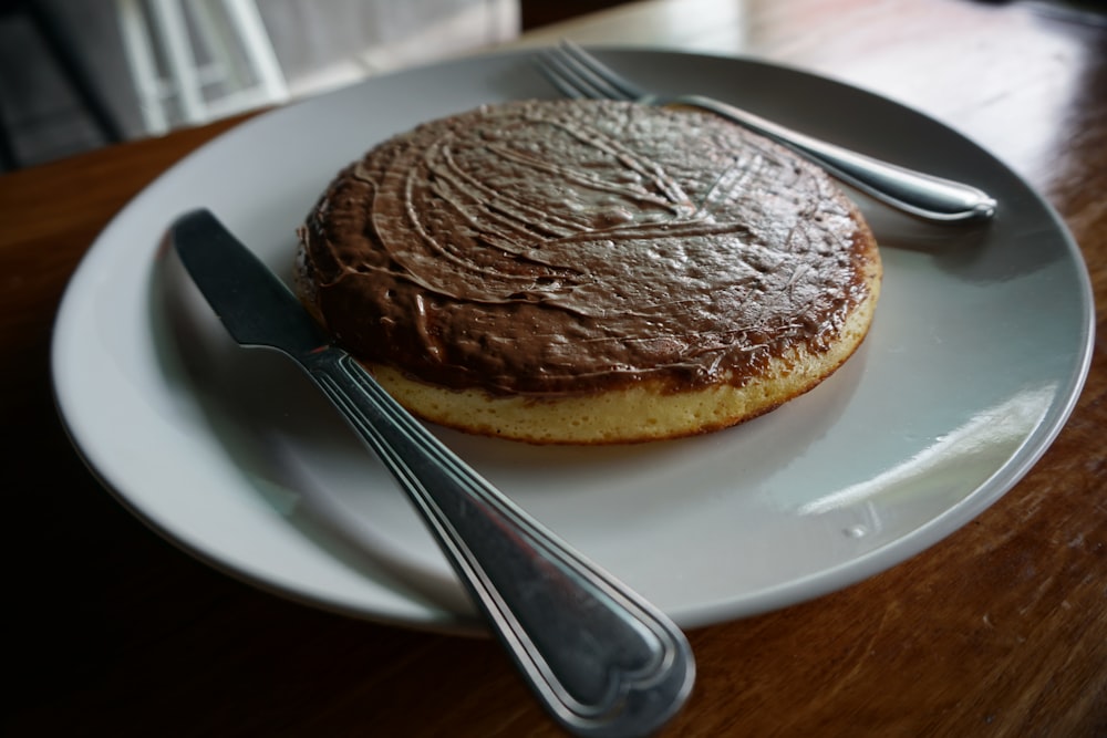 baked pastry with spoon and white plate