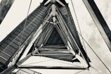 A close-up of a sturdy triangle tower against a blue sky.