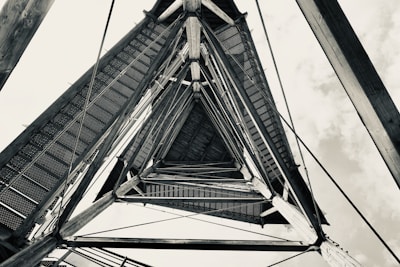 A close-up of a sturdy triangle tower against a blue sky.