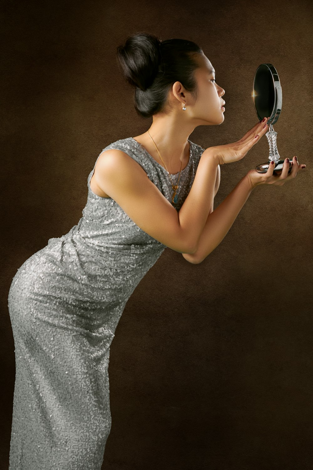 woman facing mirror