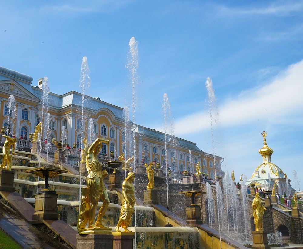 gold statue in front of building