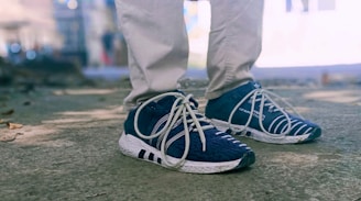 person in gray pants and blue shoes