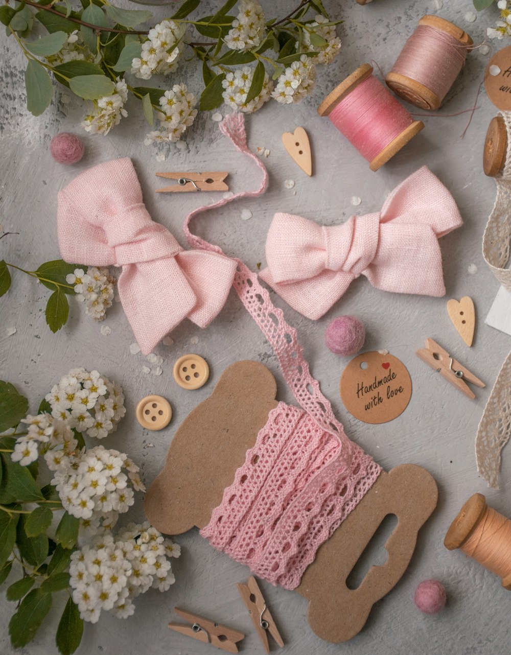 pink knitted item lot with flowers and cardboards