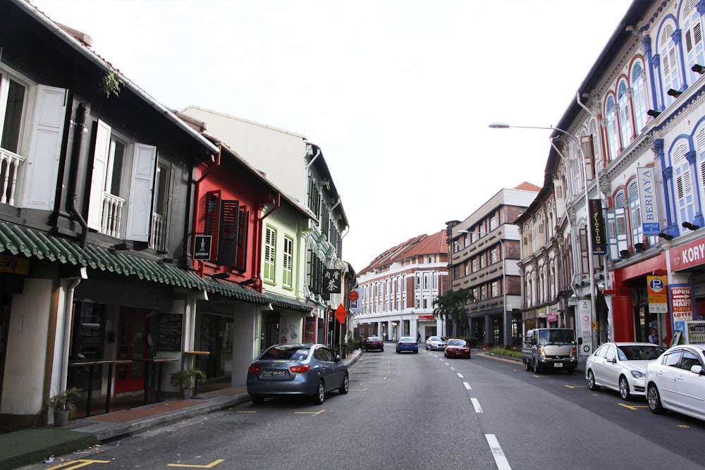 vehicles beside road and buildings