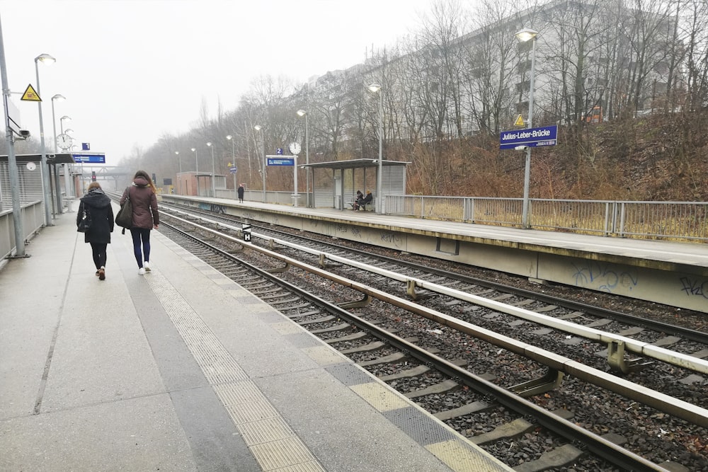 two people near train track