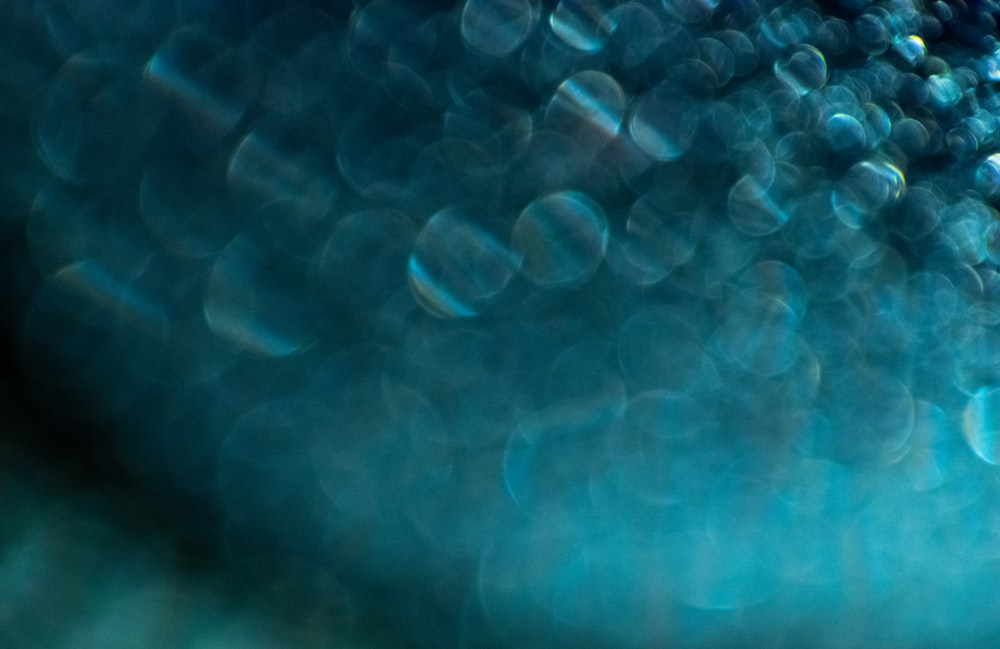 a close up of a blue background with bubbles